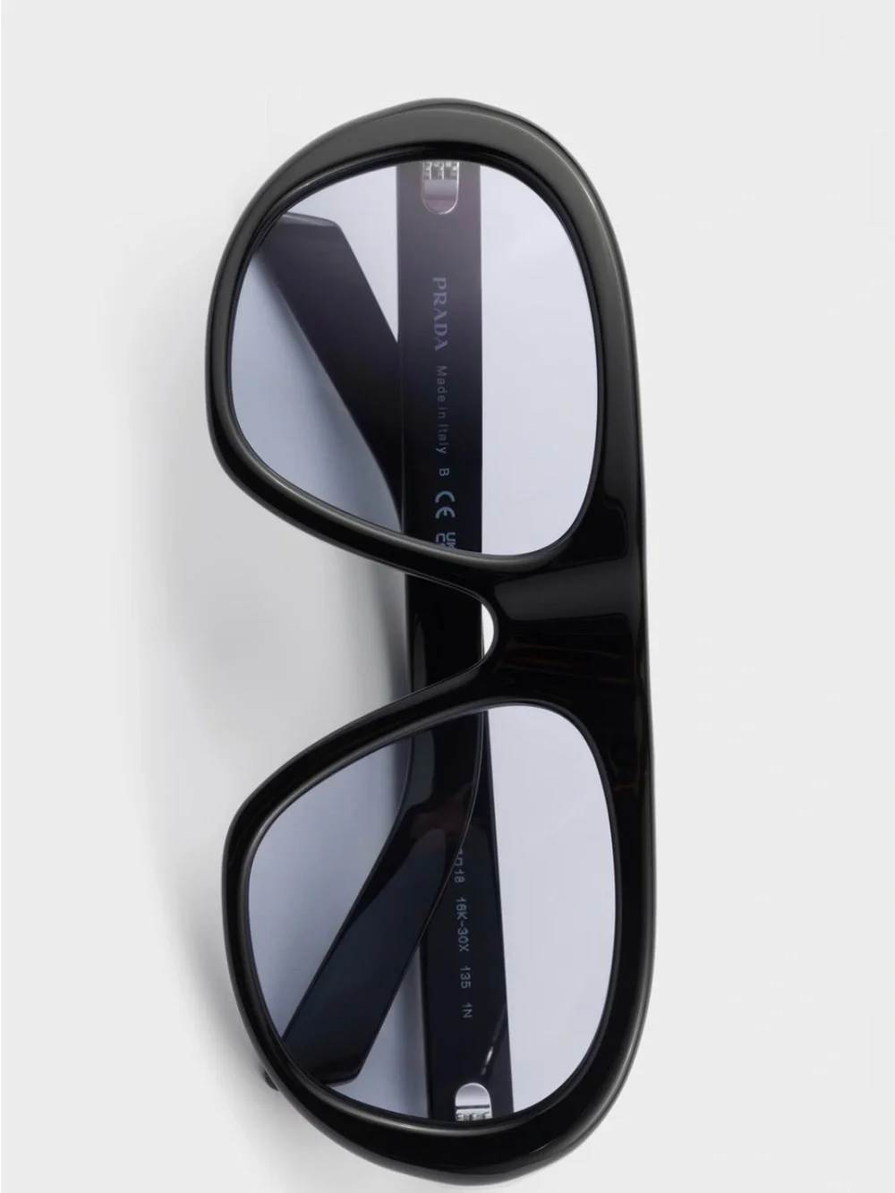 Prada Black Frame Sunglasses with Purple-Tinted Lenses